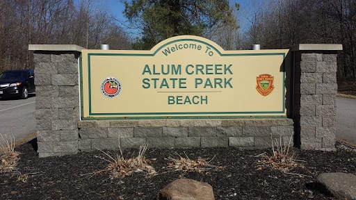 The stone and wood welcome sign at the Alum Creek State Park beach entrance
