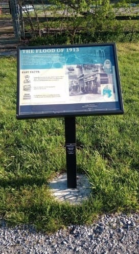 An interpretive sign titled The Flood of 1913 mounted on a post